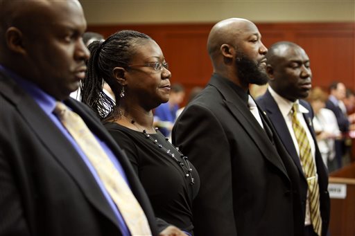 Flanked by attorneys Daryl Parks, left, and Benjamin Crump, far right, Trayvon Martin's parents Sabrina Fulton, second from left, and Tracy Martin, stand during closing arguments in George Zimmerman's trial in Seminole circuit court in Sanford, Fla. Thursday, July 11, 2013. Zimmerman has been charged with second-degree murder for the 2012 shooting death of Trayvon Martin.