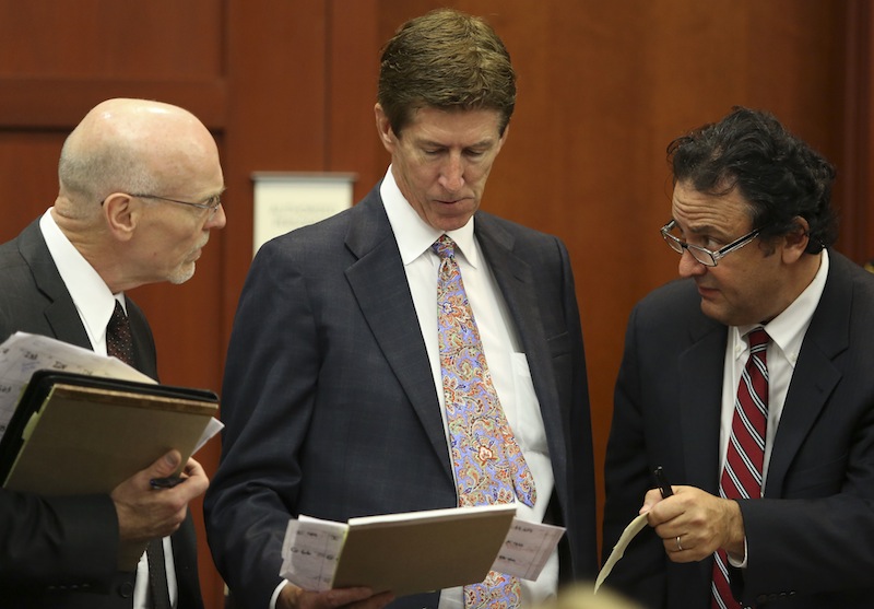 In this June 20, 2013 file photo, co-defense attorney Don West, left, defense attorney Mark O'Mara, center, and jury consultant Robert Hirschhorn go over their juror list during the final stages of jury selection in the George Zimmerman trial in Sanford, Fla. (AP Photo/Orlando Sentinel, Gary Green, Pool)