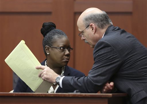 Assistant state attorney Bernie de la Rionda, right, talks to Sybrina Fulton, Trayvon Martin's mother, on the stand during a recess in George Zimmerman's trial in Seminole circuit court, Friday, July 5, 2013 in Sanford, Fla. Zimmerman has been charged with second-degree murder for the 2012 shooting death of Trayvon Martin.