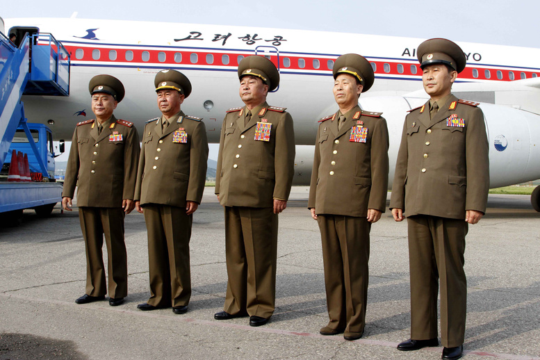North Korea's military delegation members led by chief of the General Staff of the people's army, Kim Kyok Sik, center, pose for photos before leaving for Cuba at the Pyongyang Airport on June 26. A North Korean ship carrying weapons system parts buried under sacks of sugar was seized as it tried to cross the Panama Canal on its way from Cuba to its home country, which is under a United Nations arms embargo, Panamanian officials said Tuesday.