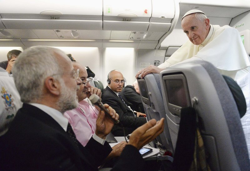 Pope Francis listens to a journalist's question as he flies back to Rome following his visit to Brazil July 29, 2013. Pope Francis, in some of the most conciliatory words from any pontiff on gays, said they should not be judged or marginalised and should be integrated into society, but he reaffirmed Church teaching that homosexual acts are a sin. In a broad-ranging 80-minute conversation with journalists on the plane bringing him back from a week-long visit to Brazil, Francis also said the Roman Catholic Church's ban on women priests was definitive, although he would like them to have more leadership roles in administration and pastoral activities. (REUTERS/Luca Zennaro/Pool) :rel:d:bm:GF2E97T12SD01