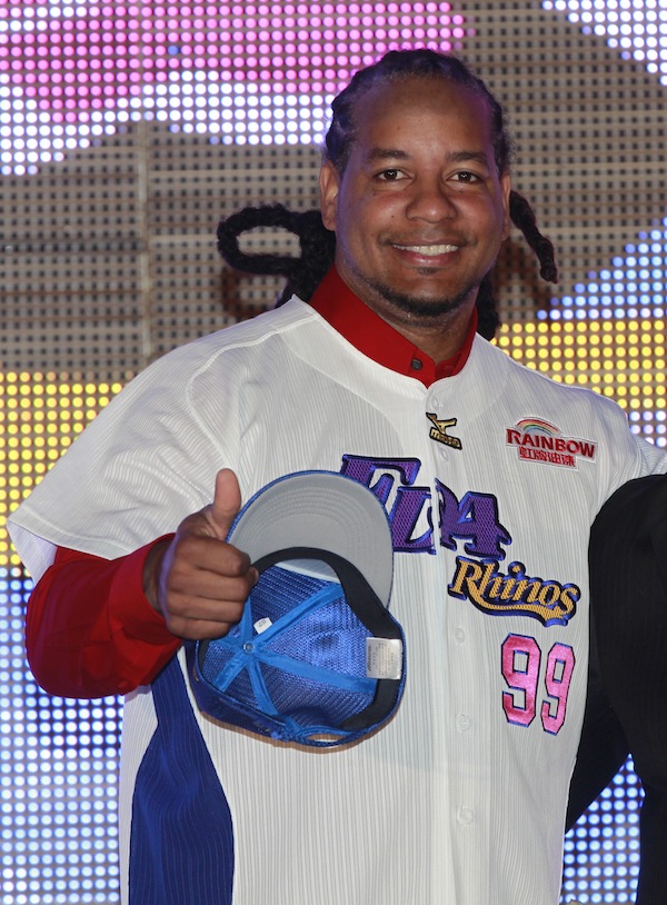 In this March 12, 2013 file photo, former Major League Baseball star Manny Ramirez poses for media wearing his new jersey after signing a short-term contract to play on the EDA Rhinos in Taiwan's professional baseball league, in Kaohsiung, Taiwan. The Texas Rangers have signed Ramirez to minor league contract. Ramirez spent three months playing in Taiwan before leaving the team on June 20. The Rangers made the announcement Wednesday, July 3, 2013. (AP Photo/Wally Santana, File)