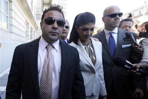 Giuseppe "Joe" Giudice, 43, left, and his wife, Teresa Giudice, 41, of Montville Township, N.J., leave the courthouse after an appearance in Newark, N.J. The two stars of the "Real Housewives of New Jersey" are charged in a 39-count indictment with conspiracy to commit mail and wire fraud, bank fraud, making false statements on loan applications and bankruptcy fraud.