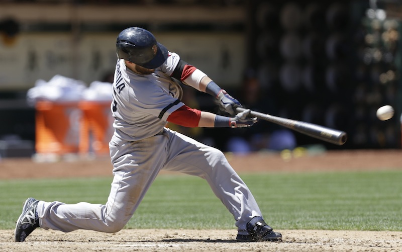 Boston Red Sox's Dustin Pedroia connects for an RBI single off Oakland Athletics' Bartolo Colon in the sixth inning of a baseball game Sunday, July 14, 2013, in Oakland, Calif. (AP Photo/Ben Margot)