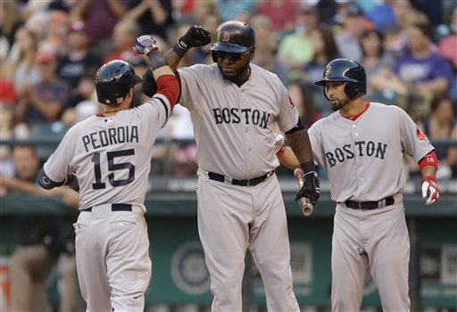 Boston Red Sox's Dustin Pedroia is greeted at the plate by Red Sox's David Ortiz, center, and Shane Victorino, right, after Pedroia hit a solo home run in the third inning of a baseball game against the Seattle Mariners, on Tuesday in Seattle.