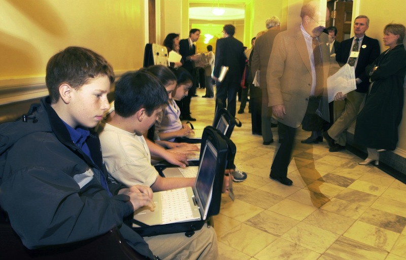 In this 2002 file photo, Shapleigh Middle School seventh-graders use their laptops in the hallway outside the Senate chamber as lawmakers and lobbyists go about business at the Maine State House in Augusta. Maine's "F" grade for government integrity, issued last year by a national group, has led to reforms in the state's ethics rules, including a bipartisan transparency bill proposed by Gov. Paul LePage that he signed into law last week. (AP Photo/Pat Wellenbach) Computers
