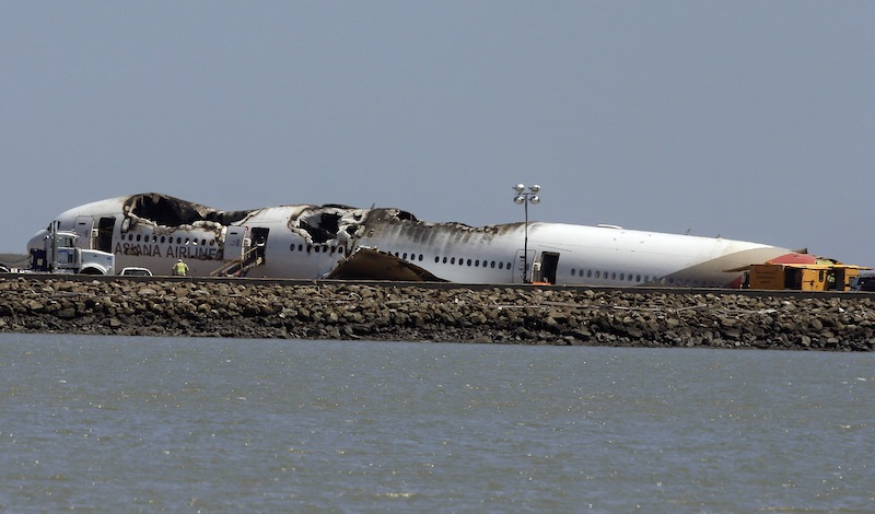 The wreckage of Asiana Flight 214, which crashed on Saturday, July 6, 2013, is seen on a tarmac at San Francisco International Airport in San Francisco, Tuesday, July 9, 2013. (AP Photo/Jeff Chiu)