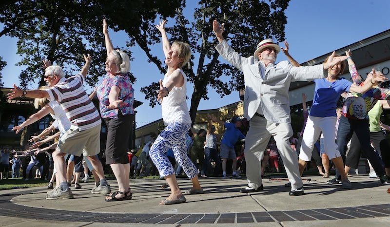 In this July 13 file photo, more than 50 seniors participate in a flash mob dance in Eugene, Oregon. A company that organizes flash mob events around the country will come to Portland in August to stage a high-visibility dance in a public place, but the organizer won't say where. (AP Photo/The Register-Guard, Chris Pietsch)