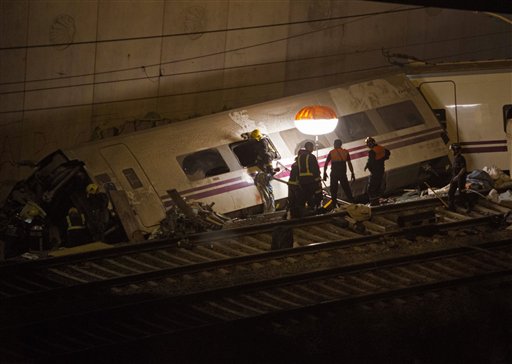 Emergency personnel conduct rescue operations Thursday at the site of a train derailment in Santiago de Compostela, Spain. The passenger train derailed Wednesday night on a curvy stretch of track in northwestern Spain, the country's worst rail accident in decades.