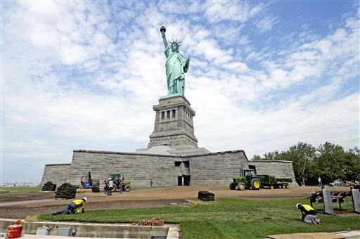 Months after railings broke, docks and paving stones were torn up and buildings were flooded by Superstorm Sandy, the Statue of Liberty reopened today in New York. AP Photo/National Park Service.