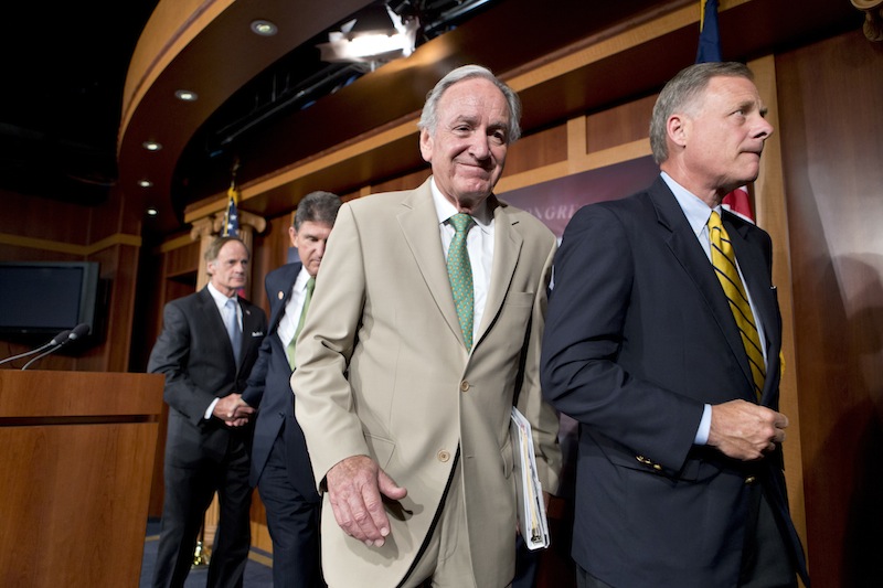 In this July 18, 2013, file photo from right, Sen.s Richard Burr, R-N.C., and Tom Harkin, D-Iowa, chair of the Senate Education Committee, leave a Capitol Hill news conference after announcing a bipartisan agreement on rates for government student loans. The House gave its stamp of approval to the Senate compromise that would link college students’ interest rates to the financial markets and offer borrowers lower rates this fall. From left are Sens. Tom Carper, D-Del. and Joe Manchin, D-W.V, (AP Photo/J. Scott Applewhite, File)