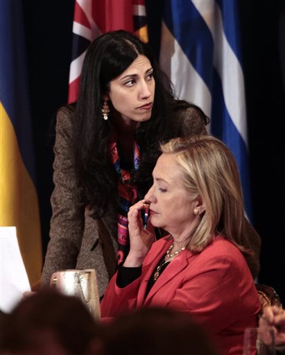 Huma Abedin, then-deputy chief of staff and aide to then-Secretary of State Hillary Rodham Clinton, right, confers with Clinton during a meeting in New York in this Sept. 20, 2011, photo.