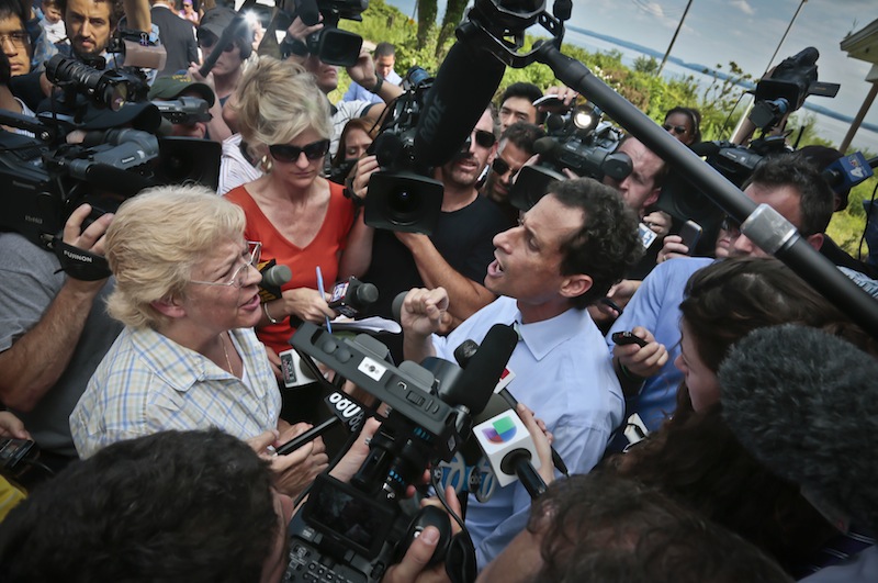 New York City mayoral candidate Anthony Weiner, right, reacts to a question from Peg Brunda during a tour of Superstorm Sandy victims on Staten Island on Friday, July 26, 2013 in New York. Brunda confronted the candidate, telling him he didn’t have the “moral authority” to lead the city, as he tries to move past the sexting scandal threatening to derail his attempted political comeback. (AP Photo/Bebeto Matthews)