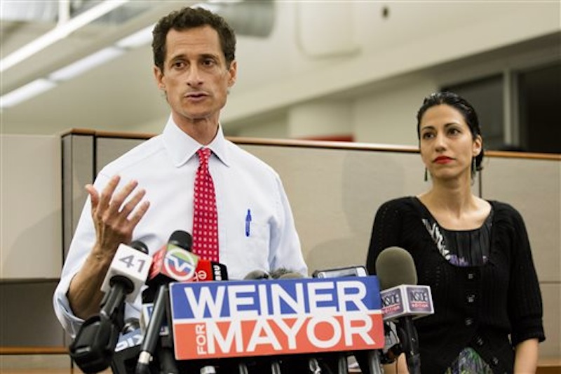 New York mayoral candidate Anthony Weiner speaks during a news conference alongside his wife Huma Abedin at the Gay Men's Health Crisis headquarters, Tuesday, July 23, 2013, in New York. The former congressman says he's not dropping out of the New York City mayoral race in light of newly revealed explicit online correspondence with a young woman. (AP Photo/John Minchillo)