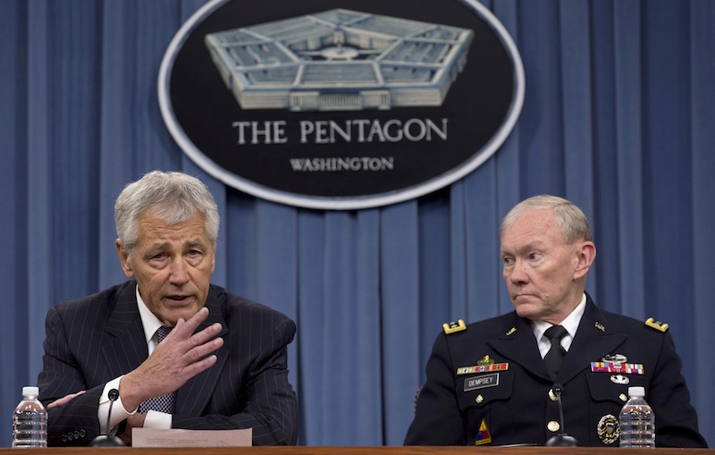 In this May 17, 2013 file photo Defense Secretary Chuck Hagel, left, and Chairman of the Joint Chiefs of Staff, Gen. Martin Dempsey take turns talking to media during a news conference at the Pentagon. Women may be able to begin training as Army Rangers by mid-2015, and as Navy SEALs a year later under broad plans Defense Secretary Chuck Hagel is approving that would slowly bring women into thousands of combat jobs, including those in the country’s elite special operations forces, according to details of the plans submitted to Hagel that were obtained by The Associated Press. (AP Photo/Carolyn Kaster, File)