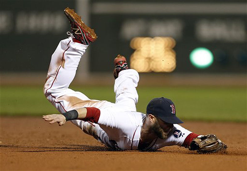 Boston's Dustin Pedroia dives for a line drive in the seventh inning against the New York Yankees in Boston on Sunday. The Red Sox won in the 11th, 8-7.