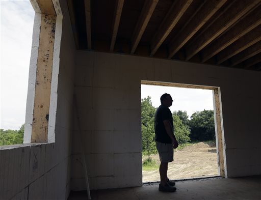 Gil Lobell stands in a zero net energy home being built at The Preserve at Mountain Vista in New Paltz, N.Y. Exterior walls of the nine homes under construction include a 6-inch layer of poured, reinforced concrete sandwiched by about 2½ inches of polystyrene.