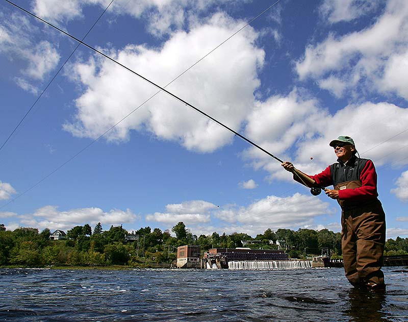 Pete Brunner of Falmouth casts for Atlantic salmon in the Eddington Pool on the Penobscot River below the Veazie Dam in Eddington. Just 20 years ago, the first salmon pulled from the Penobscot River each season was sent to the White House. Now Atlantic salmon have virtually disappeared, and are off limits to fishing. Environmentalists hope a dam removal that starts Monday, opening miles of river to migrating fish, will help efforts to restore endangered salmon.