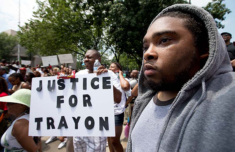 Ibn Akbar from Boston joins a "Justice for Trayvon -100 City Vigil" Saturday as they demonstrate in front of the federal court in Washington.