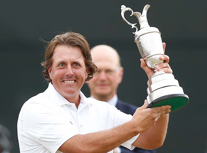 Phil Mickelson of the United States holds up the Claret Jug trophy after winning the British Open Golf Championship at Muirfield, Scotland, Sunday July 21, 2013. (AP Photo/Matt Dunham)