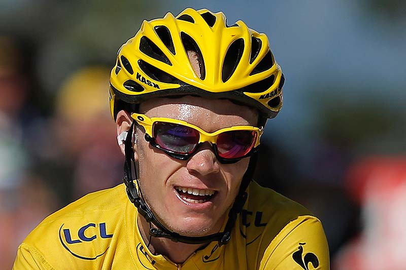 Christopher Froome, wearing the overall leader's yellow jersey, is all smiles as he crosses the finish line in the 20th stage of the Tour de France on Saturday.