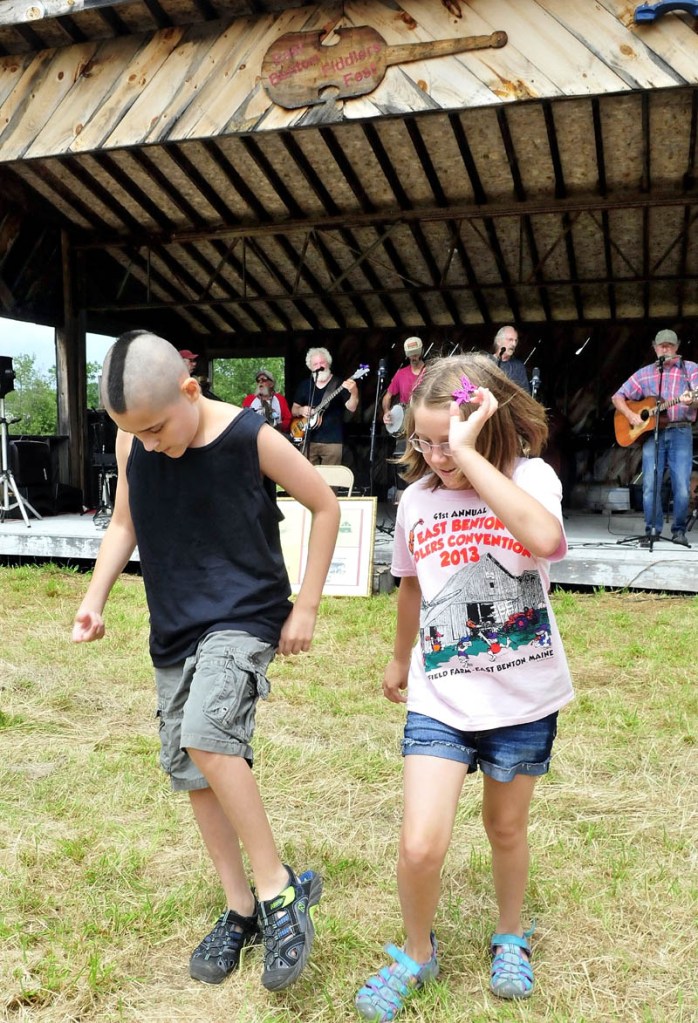 Gerry Moody and his sister Angel got up to dance a jig as the Country Choir band performs during the 41st East Benton fiddlers festival on Sunday.