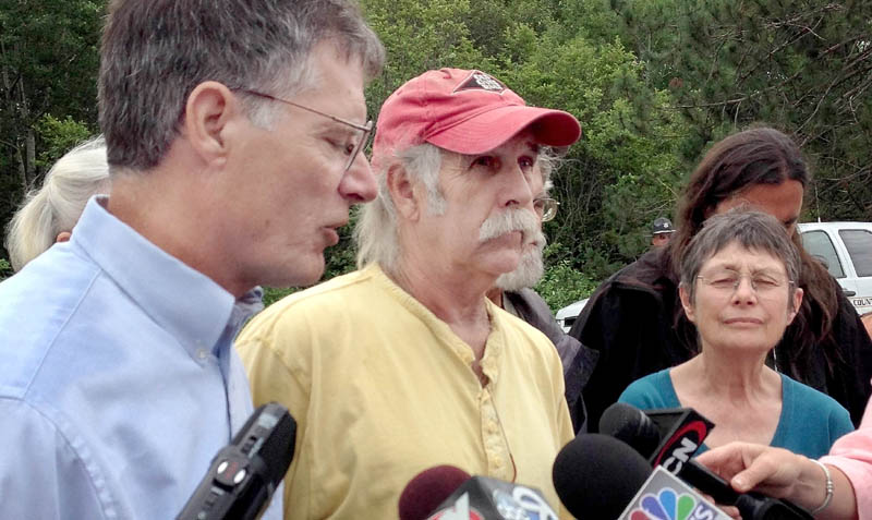Read Brugger, left, Jim Freeman and Nancy Galland were among a group of demonstrators in Hermon Monday who called for more stringent inspection of Maine railways following the deadly in train derailment in Quebec.