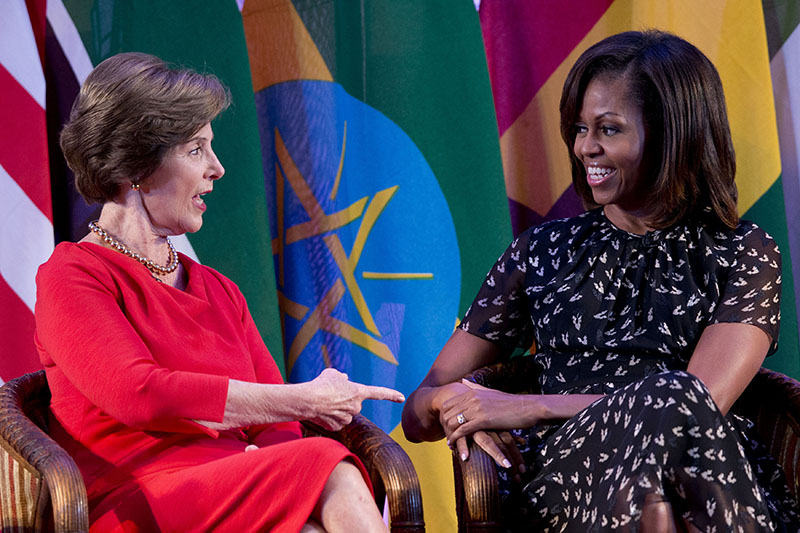 U.S. first lady Michelle Obama, right, and former U.S. first lady Laura Bush talk each other as they participate in the African First Ladies Summit: “Investing in Women: Strengthening Africa,” hosted by the George W. Bush Institute, Tuesday, July 2, 2013, in Dar es Salaam, Tanzania. (