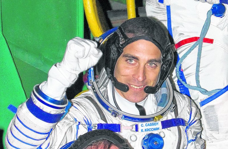 In this file photo, U.S. astronaut Christopher Cassidy, crew member of the mission to the International Space Station (ISS), waves prior to the launch of Soyuz-FG rocket at the Russian leased Baikonur Cosmodrome, Kazakhstan, Thursday, March 28, 2013.