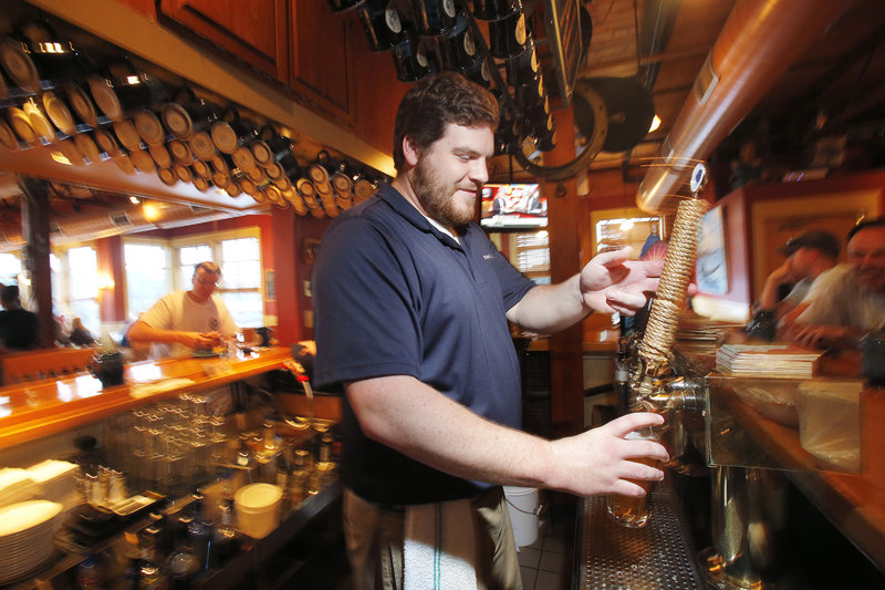Liam Burns pours a Sunfish Wheat at Federal Jack’s in Kennebunk.