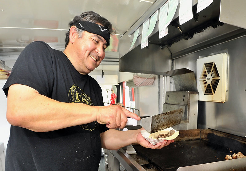 Joe Urtuzuastegui whips up a taco in his El Corazon food truck.