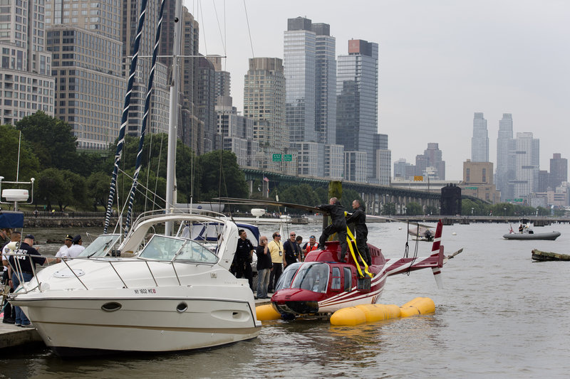 A helicopter rests on pontoons after making an emergency landing on the Hudson River in New York on Sunday.