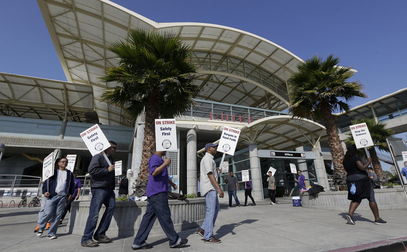 Bay Area Rapid Transit workers picket outside of a station in Millbrae, Calif. The union wants a 5 percent raise each year for three years; BART has offered 8 percent, total, over four years.