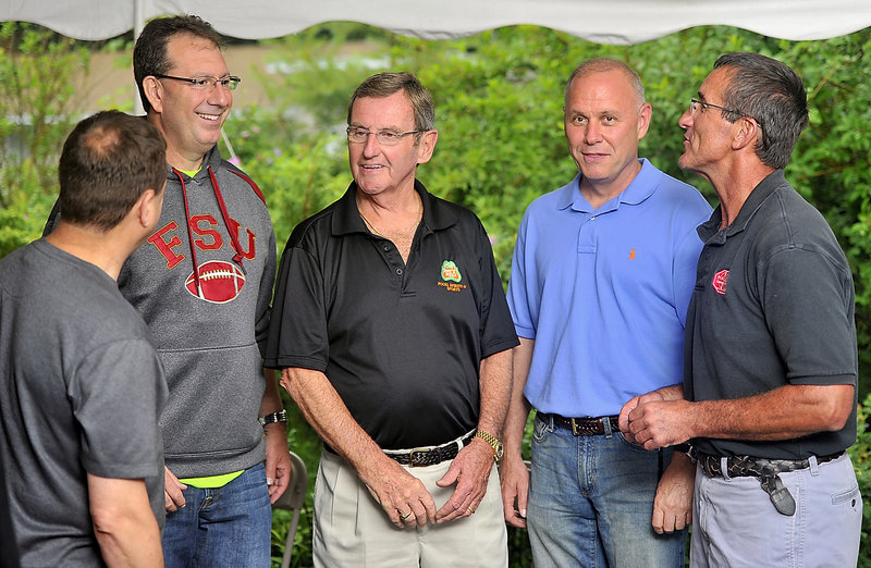 Former Cumberland resident Peter Bickmore, second from right, spends time with friends during a gathering in Yarmouth. From left are Sgt. Michael Edes of the Maine State Police; David Goodman, with the Tampa (Fla.) police; John Kyle, owner of Pat’s Pizza in Yarmouth; and Lt. Milt Calder of the town of Cumberland police.