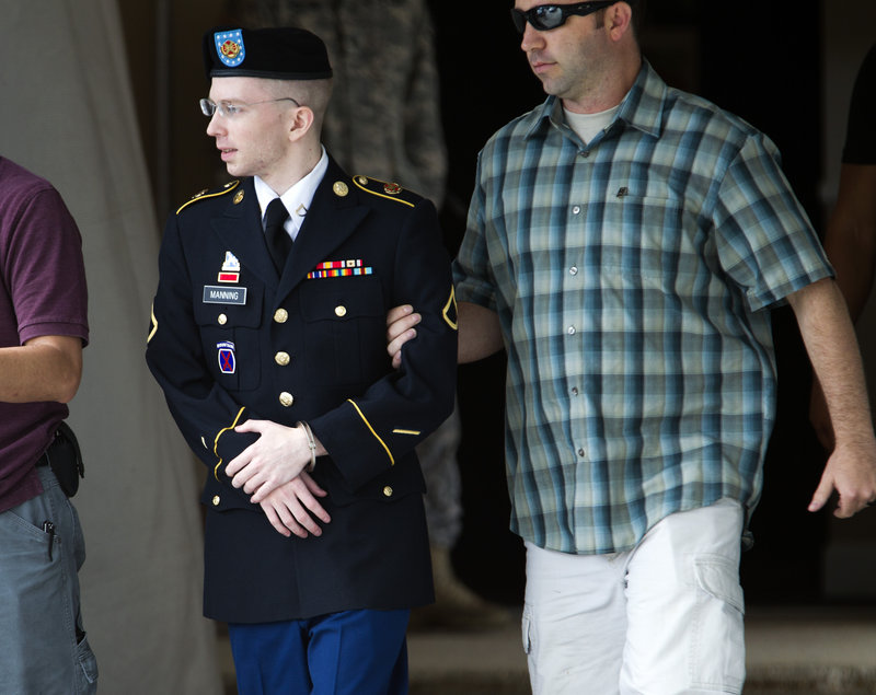 Army Pfc. Bradley Manning is escorted out of the courthouse in Fort Meade, Md., where he is charged with indirectly aiding the enemy by sending classified material to WikiLeaks.