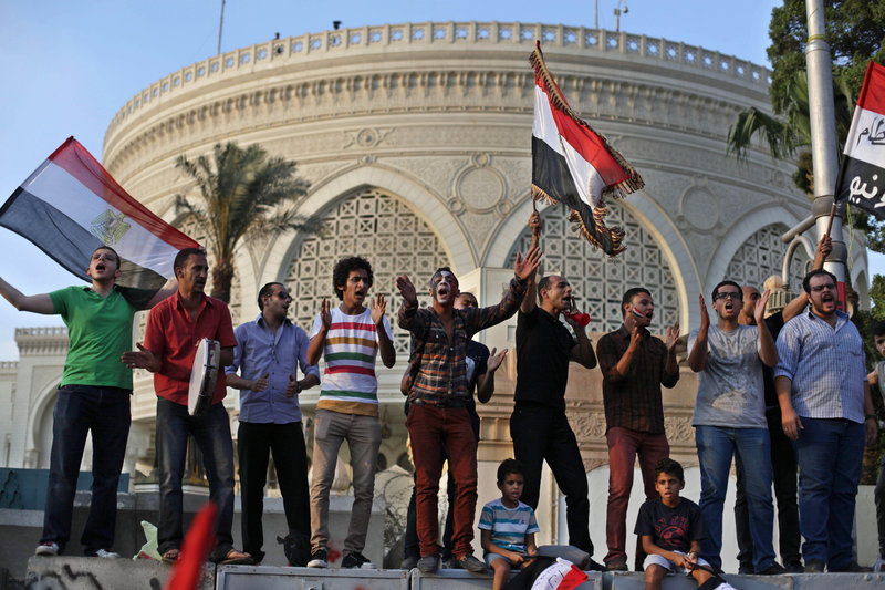 Protesters call for the ouster of President Mohammed Morsi outside the presidential palace in Cairo on Tuesday. Clashes broke out between protesters and Morsi supporters.