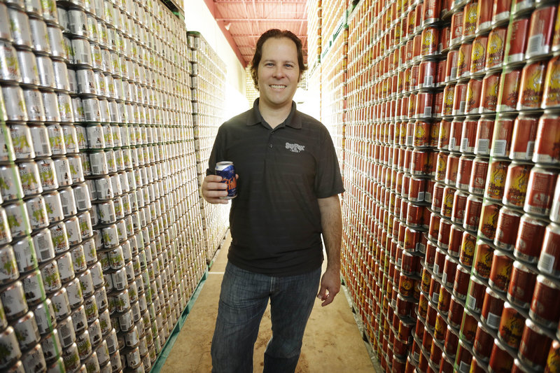 Brewmaster Brian O’Reilly holds a can of Helles Golden Lager with a 360 Lid at the Sly Fox Brewing Co. in Pottstown, Pa.