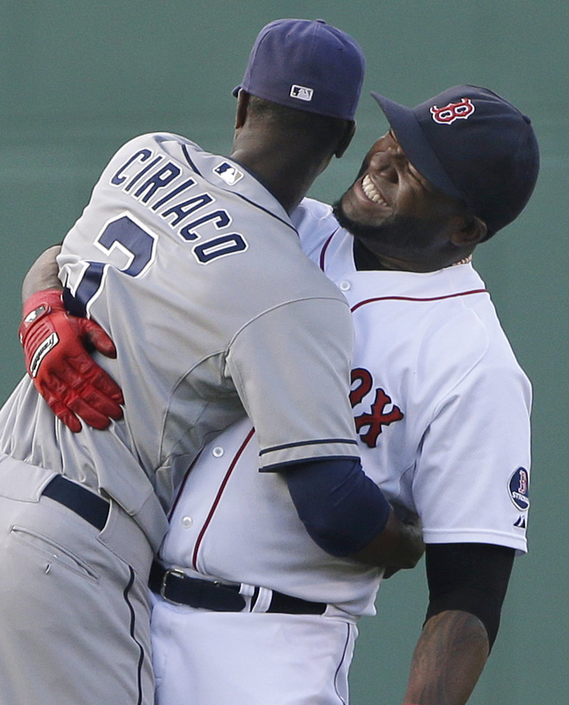 Boston’s David Ortiz, right, hugs former teammate Pedro Ciriaco of the Padres before Tuesday’s game.