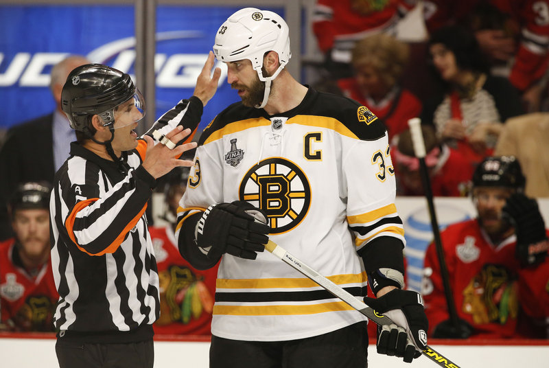 Wes McCauley explains a situation to the Bruins’ captain, defenseman Zdeno Chara, during a Stanley Cup finals game in Chicago.