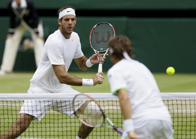 Juan Martin del Potro of Argentina, left, plays a return to David Ferrer of Spain during their Wimbledon quarterfinal. Del Potro will meet top-seeded Novak Djokovic after earning a straight-set victory.
