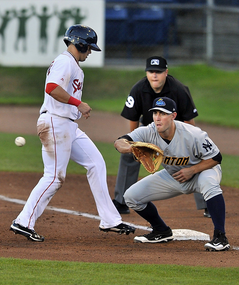 Shannon Wilkerson of the Portland Sea Dogs gets back to first base in time Wednesday night as Andrew Clark of the Trenton Thunder takes the pickoff throw during the Sea Dogs’ 7-0 victory at Hadlock Field.
