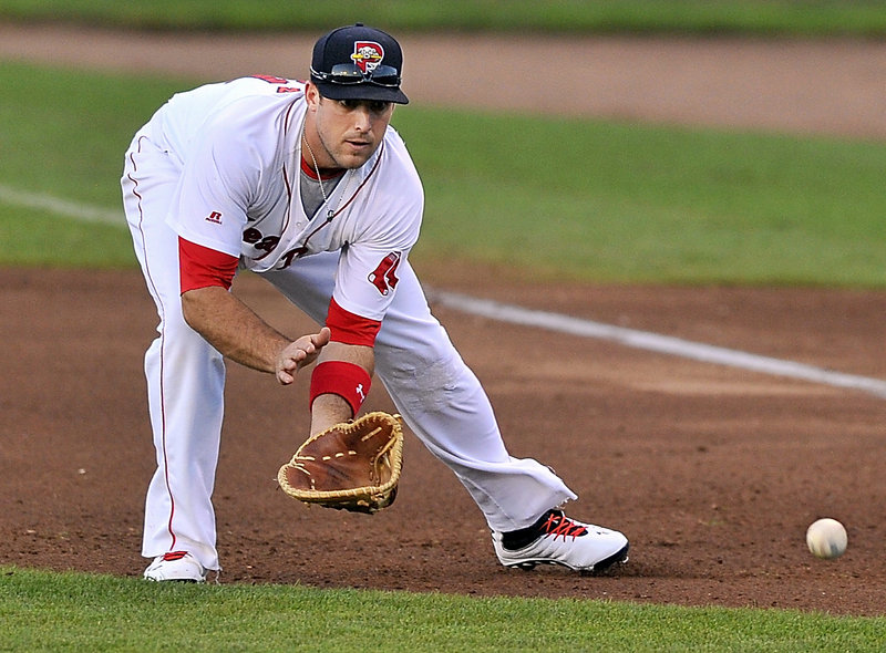 Travis Shaw of the Portland Sea Dogs prepares to snag a grounder Wednesday night, the start of a first baseman-to-shortstop-to-first baseman double play at Hadlock Field.