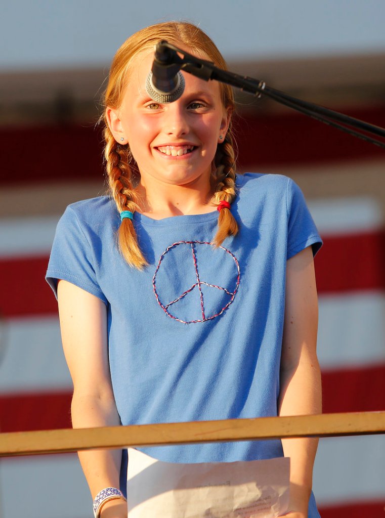The microphone could use some adjusting as 11-year-old Hope Carroll of Portland gets ready to read her contest-winning essay, “What Freedom Means to Me,” during the Stars and Stripes Spectacular Fourth of July celebration Thursday on Portland’s Eastern Prom.
