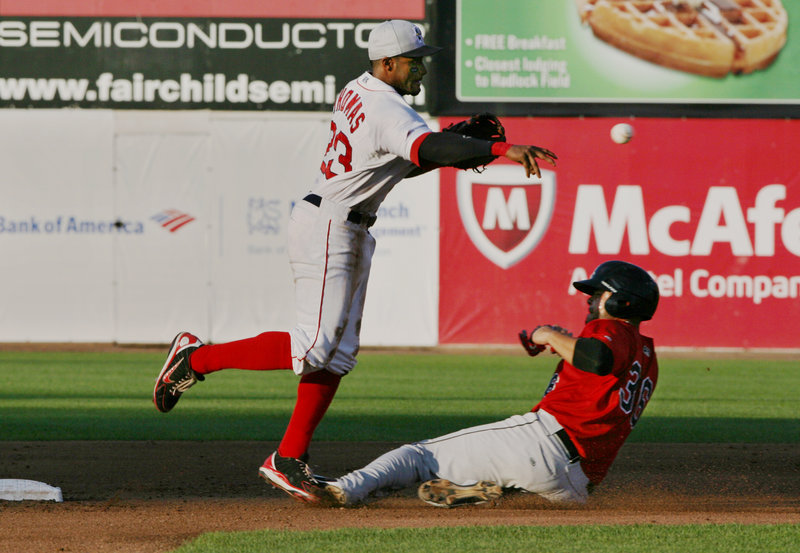 Tony Thomas of the Portland Sea Dogs throws to first in an unsuccessful attempt for a double play Thursday night after forcing Josmil Pinto of New Britain at second base.