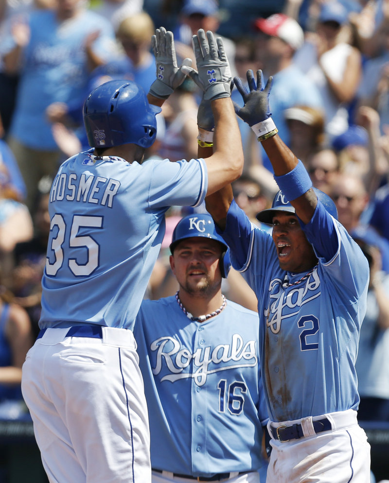 Eric Hosmer gets high-fives from teammates after his two-run homer put the Royals ahead of the Indians in Thursday’s 10-7 victory in Kansas City.