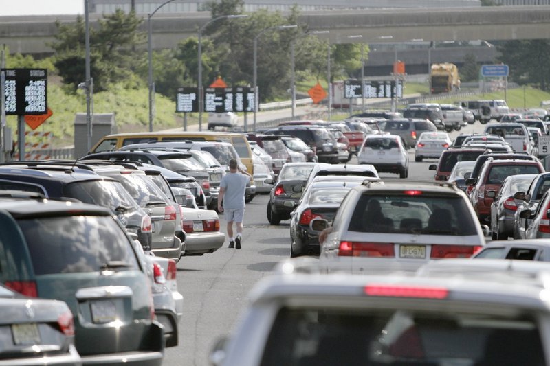 Cars make their way through the cellphone lot at Philadelphia International Airport on June 19. The free parking areas, where people picking up travelers can wait, have sprung up at airports around the country.