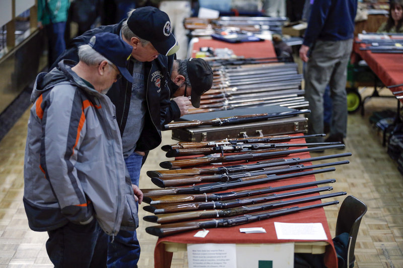 Rifles are displayed at a gun show in Albany, N.Y., in January. A reader says Maine could take a leadership role in preventing gun violence by requiring background checks before private and gun show sales.