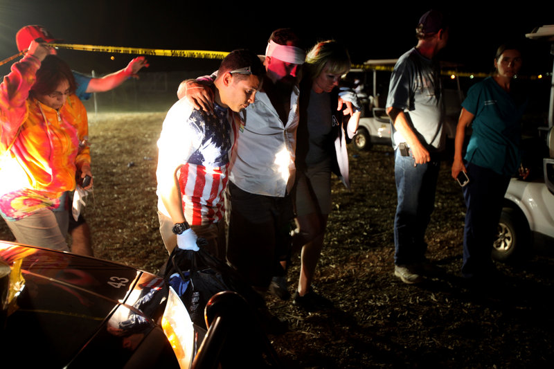 An injured man is assisted after a fireworks accident on Thursday in Simi Valley, Calif. At least 36 people were hurt.