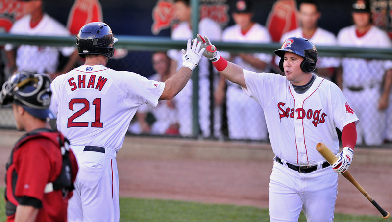 Travis Shaw receives a high-five from J.C. Linares after hitting a solo homer in the second inning. It was the 10th home run of the season for Shaw.