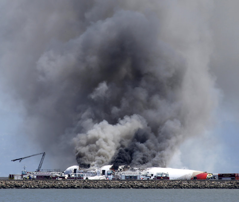 Smoke billows from the crashed Asiana Flight 214 at San Francisco International Airport on Saturday. The cause of the crash is under investigation, and terrorism has been ruled out.